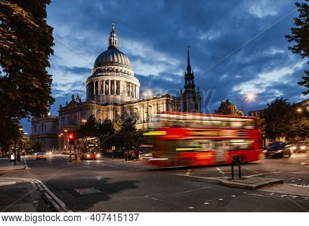 London cityscape with Double Decker bus moves along the Cannon Street near St Paul's Cathedral in twilight