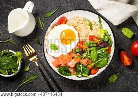 Savory Breakfast. Oatmeal Porrige With Salted Salmon, Egg And Fresh Salad. Top View On Black Table.