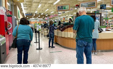 People Waiting In Line To Purchase Lottery Tickets At A Publix Grocery Store