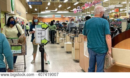 People Waiting In Line To Purchase Lottery Tickets At A Publix Grocery Store