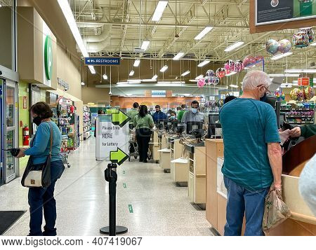 People Waiting In Line To Purchase Lottery Tickets At A Publix Grocery Store