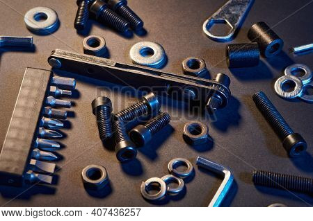 Different Screws, Nuts, Washers, Screwdrivers On Black Background. Hardware Tools And Metal Bolts, N