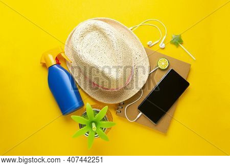 Summer Holiday Compozition With Straw Hat, Pineapple Drink Glass, Smartphone, Notebook, Yellow Backg