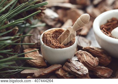 Mortar Of Powdered Pine Bark, Branches Of Pine Tree And Dry Pine Bark On Wooden Board.