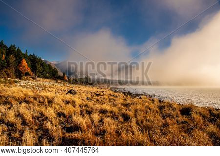 Mist Fog And Low Cloud Hanging Over The Water At The Start To A Cold Beautiful  Day At Lake Ohau