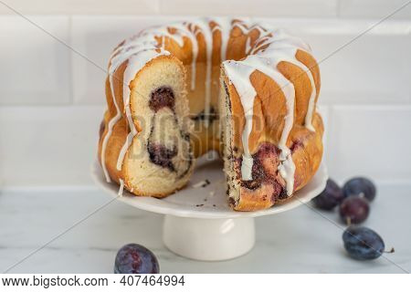 Typical German Poppy Seed Plum Gugelhupf Cake On A Table