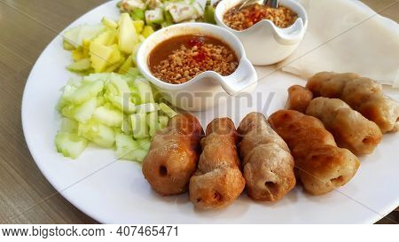 Close Up Vietnamese Meatball Wrap With Fresh Slices Of Cucumber, Sour Mango, Garlic, Raw Banana And 