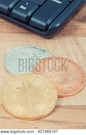 Bitcoins And Compuer Keyboard In Background, Symbol Of Electronic Virtual Money And Mining Cryptocur
