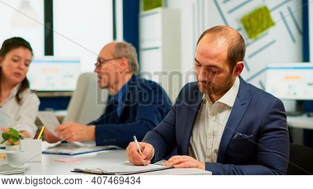 Businessman Reading Paper Document, Discussing Contract With Confident Partner, Signing Investment P