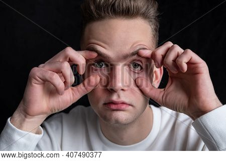 Young Guy, Tired Sleepy Student Opens His Eyes With His Hands