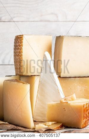 Assorted Manchego Cheese On Aged Table, Various Types Of Cheese Composition On A Light Background, V