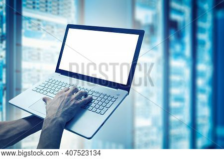 Server Support And Maintenance - Network Engineer Working On Laptop In Cloud Storage Data Center. Mo