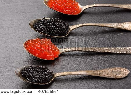 Caviar Of Paddlefish Fish And Red Chum Salmon Caviar In A Spoon, Black Background, Top View