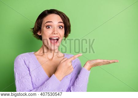 Photo Of Astonished Pretty Lady Open Mouth Indicate Finger Empty Space Arm Hold Product Isolated On 