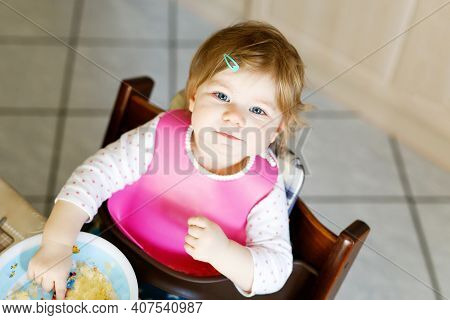 Adorable Baby Girl Eating From Spoon Mashed Vegetables And Puree. Food, Child, Feeding And People Co