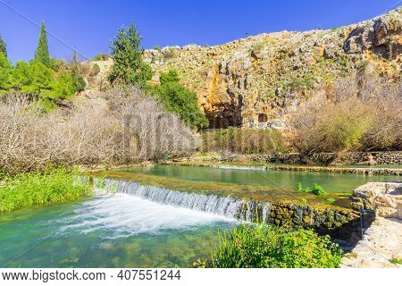 View Of A Water Stream, With The Remains Of The Shrine And Cave Of Pan In The Background, In The Her