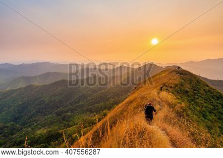 Traveler Man Hiking Enjoying In The Mountains With Backpack At Khao Chang Puak Mountain Thailand