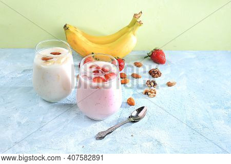 Strawberry And Banana Smoothies, Yogurt With Berries And Honey On A Bright Table.useful Breakfast Wi