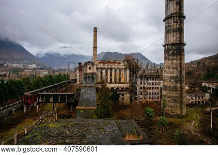 Overgrown Ruins Of Industrial Building. Abandoned, Destroyed By War Power Plant In Tkvarcheli Tquarh