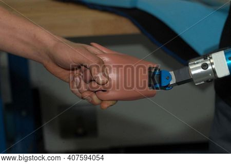 Human Hand Touches Prosthetic Hand