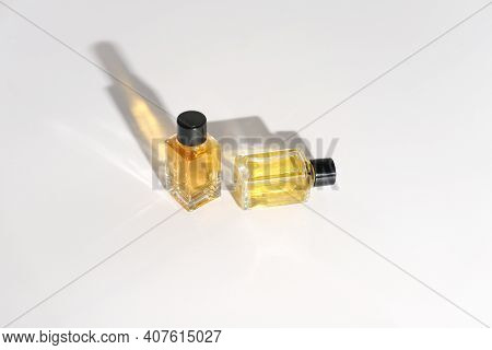 Two Perfume Bottles On A White Background. Travel Size Fragrance Bottles. Sample Mini Perfume For Wo