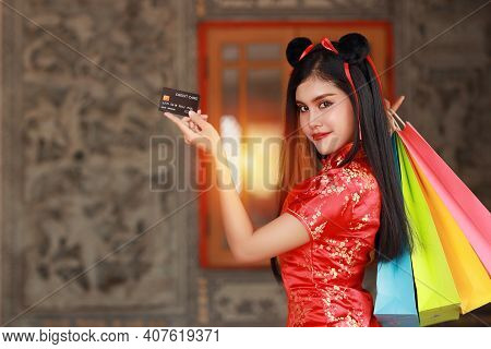 Beautiful Asian Woman In Red Chinese Dress Traditional Cheongsam Qipao With Gesture Of Showing Credi