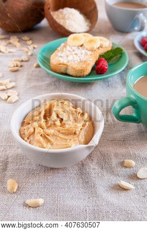 Cup With Peanut Butter And Coke Flakes. In The Background There Is A Sandwich And Cups Of Drinks. Cl