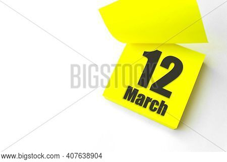 March 12nd. Day 12 Of Month, Calendar Date. Close-up Blank Yellow Paper Reminder Sticky Note On Whit