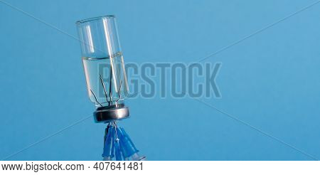 A Bottle Of Medicine, Turned Upside Down, And Five Medical Needles From Injections, Stuck In The Bot