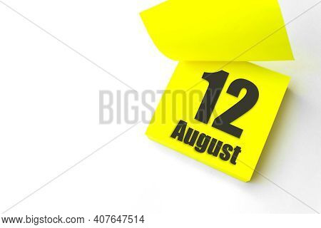 August 12nd. Day 12 Of Month, Calendar Date. Close-up Blank Yellow Paper Reminder Sticky Note On Whi