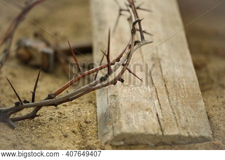 Crown Of Thorns And Wooden Plank On Sand, Closeup. Easter Attribute