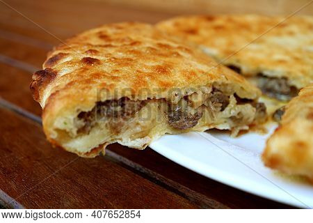 Closeup Of A Sliced Of Kubdari, Tasty Georgian Flat Bread Stuffed With Spiced Beef, Traditional Dish