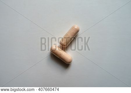 2 Pink Capsules Of Probiotic Dietary Supplement From Above