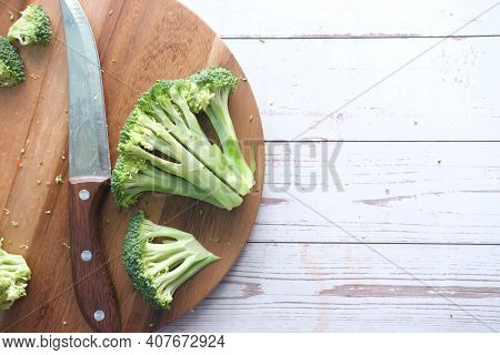 Slice Of Brocoli And Chopping Board On Table