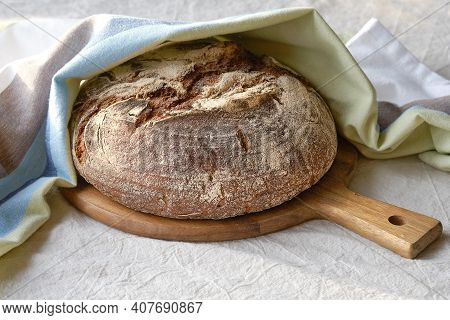 No Knead Handmade Loaf On Cutting Board. German Bauernbrot Means Farmers Bread In English. Wholemeal