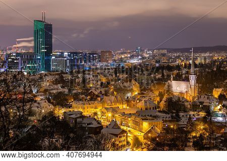 Gdansk, Oliwa, Poland - 16 January 2021 - View Of The Illuminated, Snow-covered Old Town In Oliwa. C