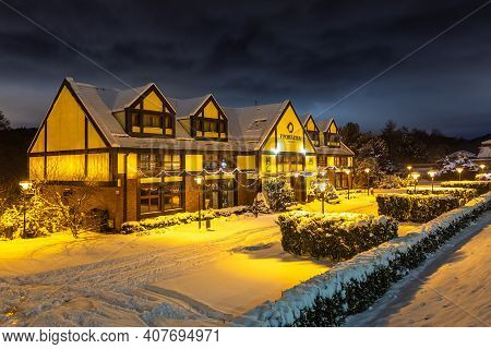 Gdansk, Oliwa, Poland - 16 January 2021 - View Of The Illuminated, Snow-covered Old Town In Oliwa. F