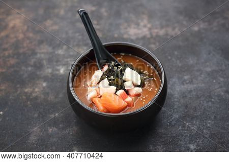 A Close-up Of A Traditional Japanese Soup. A Misoshiru With Salmon And Seafood.