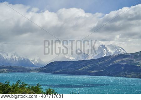 Horns Of Torres Del Paine Towering Over The Turquoise Water Of Lake Pehoe And A Mountain Ridge With 