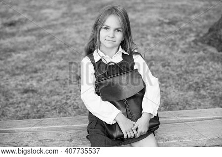 Bright From Start. Little Kid With School Bag Sit On Bench. Formal Schooling. Back To School Supplie