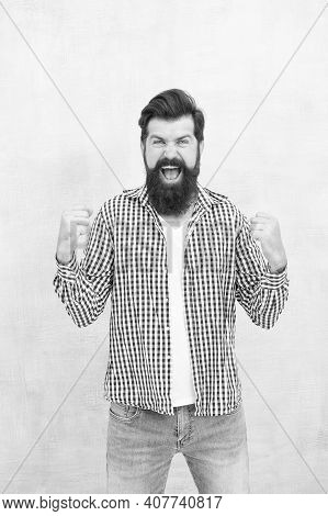All It Takes Is All Youve Got. Happy Hipster Celebrate Victory Blue Background. Bearded Man Keep Arm