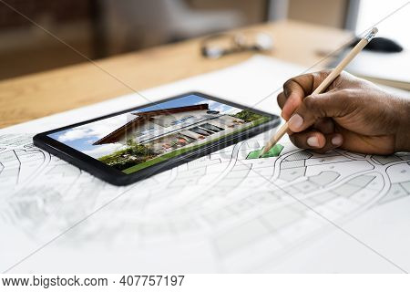 African American Hand Working With House Building Cadastre Map