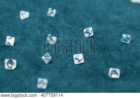 Several Large Faceted Diamonds Lie On The Blue Velvet. Close-up Photo.