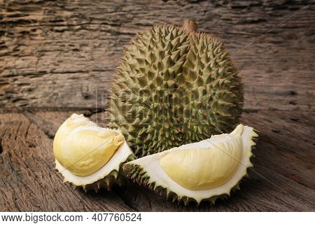 Durian riped and fresh, Durian peel with yellow color on old wood background. king of fruit from Tha
