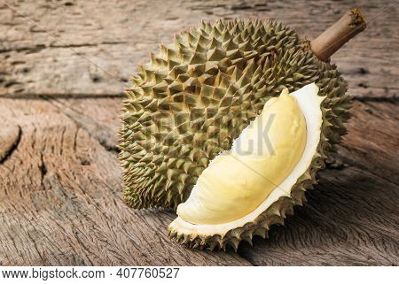Durian Riped And Fresh, Durian Peel With Yellow Color On Old Wood Background. King Of Fruit From Tha
