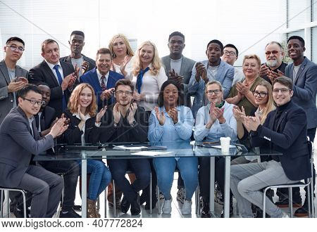 a group of businessmen applaud each other, emphasizing their suc
