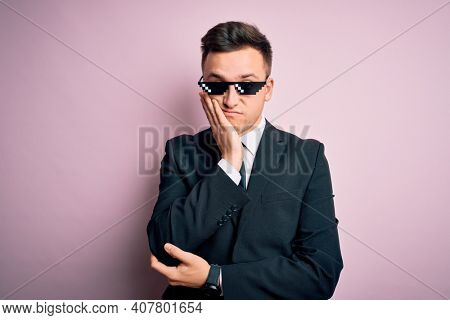 Young handsome caucasian business man wearing funny thug life glasses thinking looking tired and bored with depression problems with crossed arms.