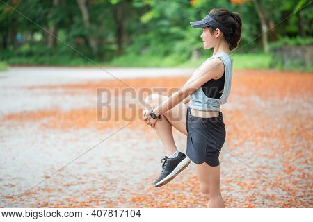 Portrait Of Runner Woman Doing Stretching And Warming Up Her Body Before Running. The Benifit Of Str