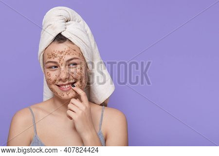 Smiling Adorable Female Posing Isolated Over Lilac Wall, Looking Aside With Flirting Facial Expressi