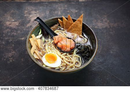 A Traditional Japanese Ramen With Salmon, On A Black Stony Background.